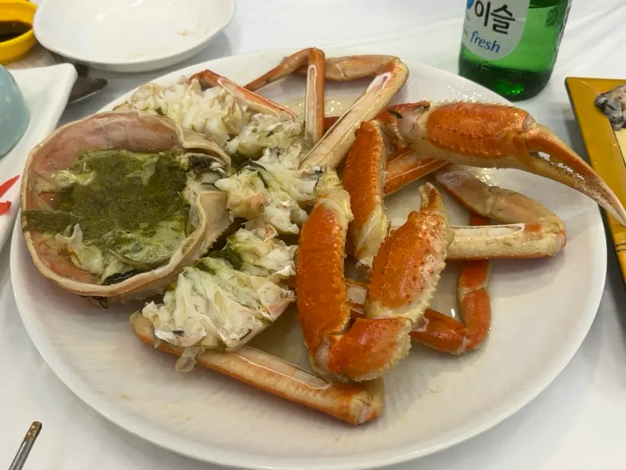Eating snow crab at an outdoor seat with a sea view