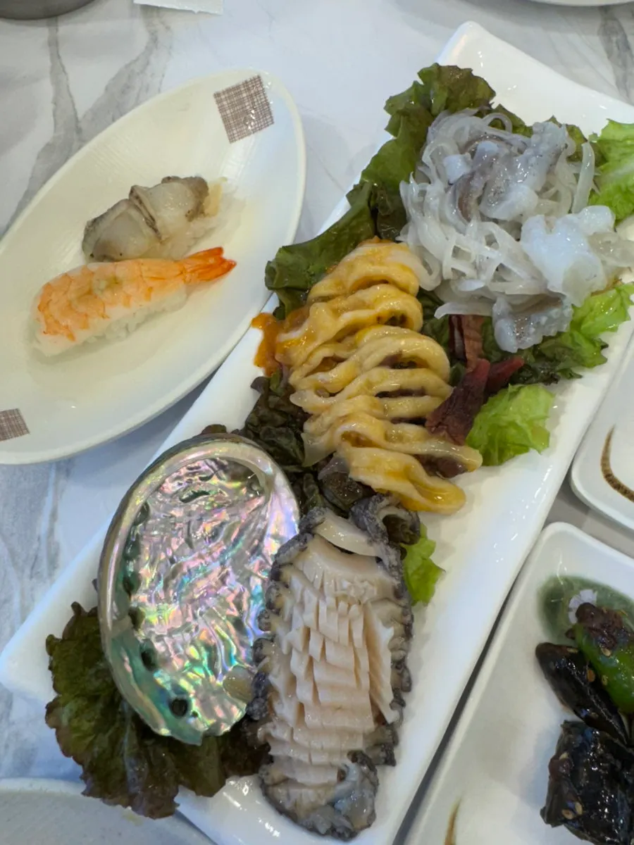 A spread of abalone, sea squirt, squid, and sushi