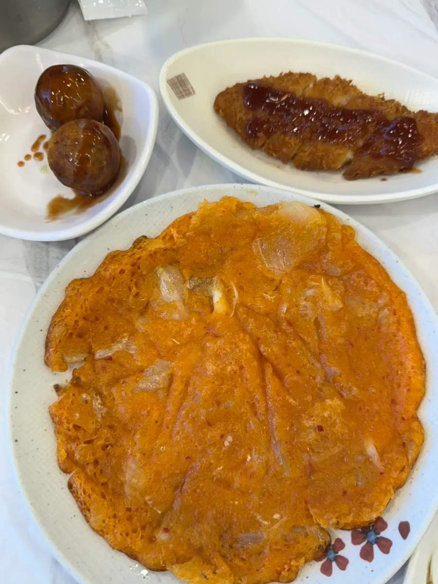 Warm side dishes of kimchi pancake, pork cutlet, and takoyaki
