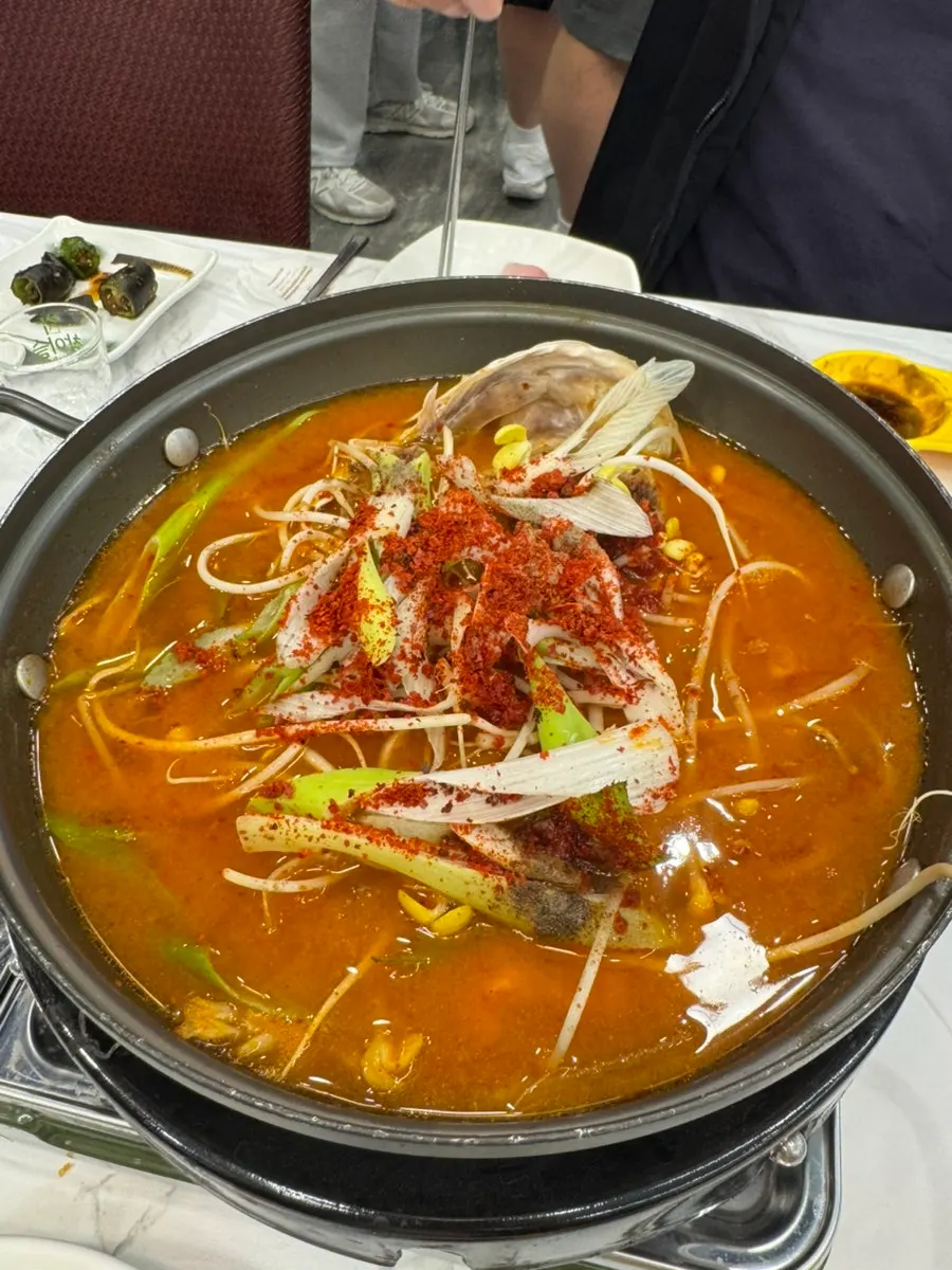 Spicy fish stew simmering at the table