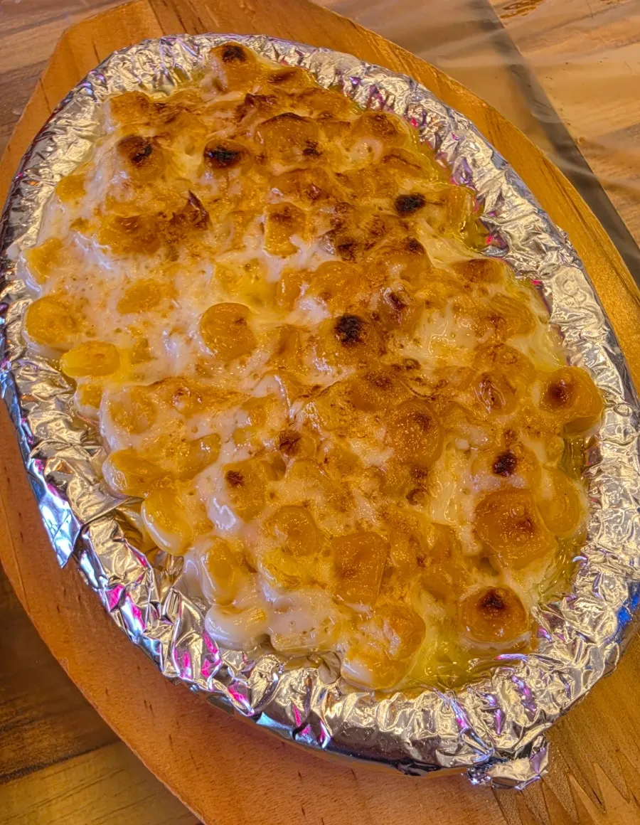 Warm corn cheese served at the table