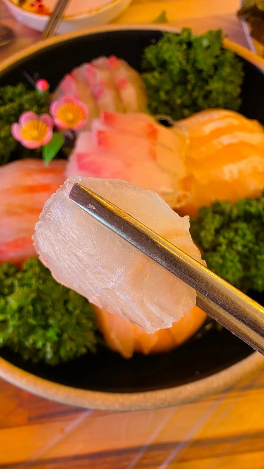 A thick-cut piece of live fish sashimi