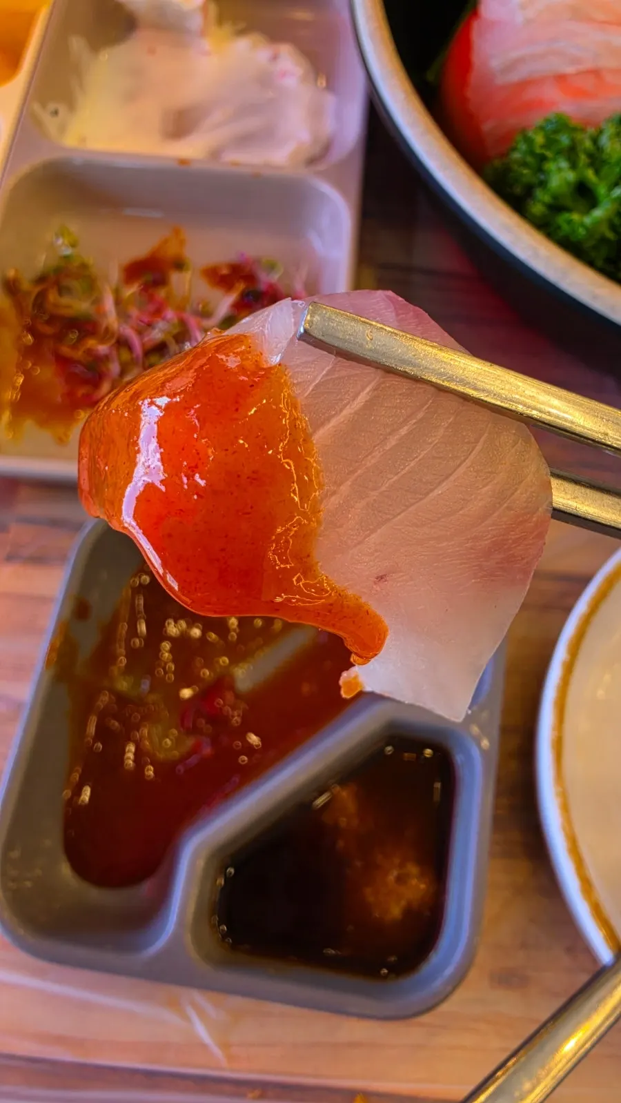 Sashimi and garlic wrapped in lettuce for a ssam