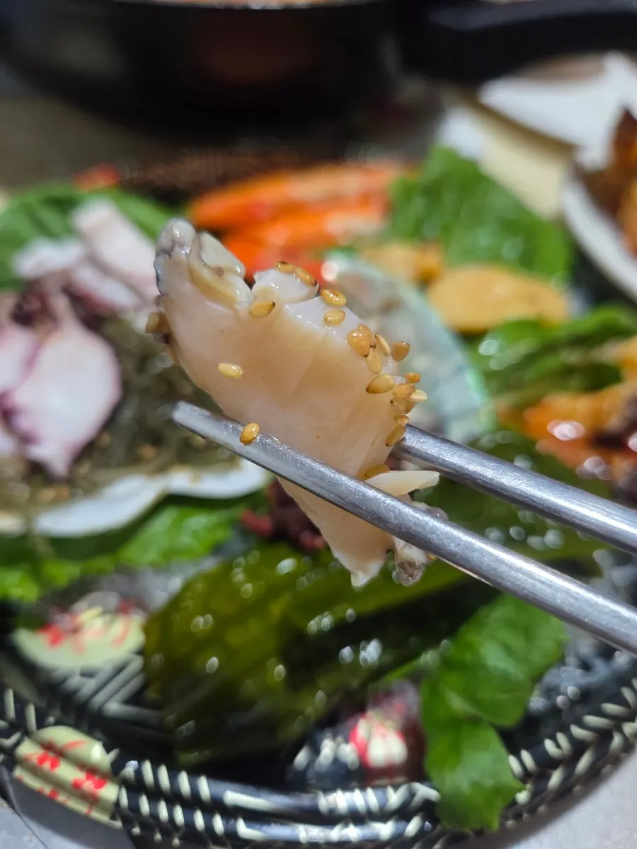 A piece of blanched octopus dipped in chili paste