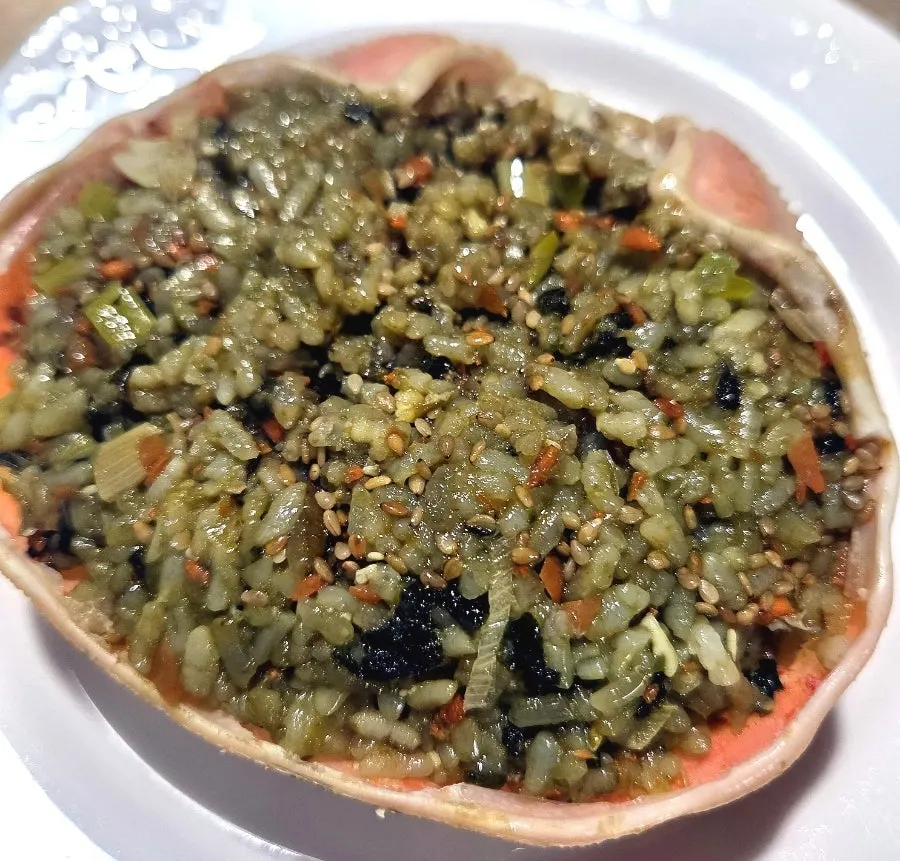 Crab shell fried rice topped with crab meat