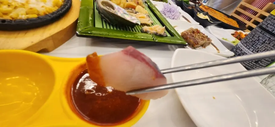 Two pieces of octopus sushi and red seabream sashimi