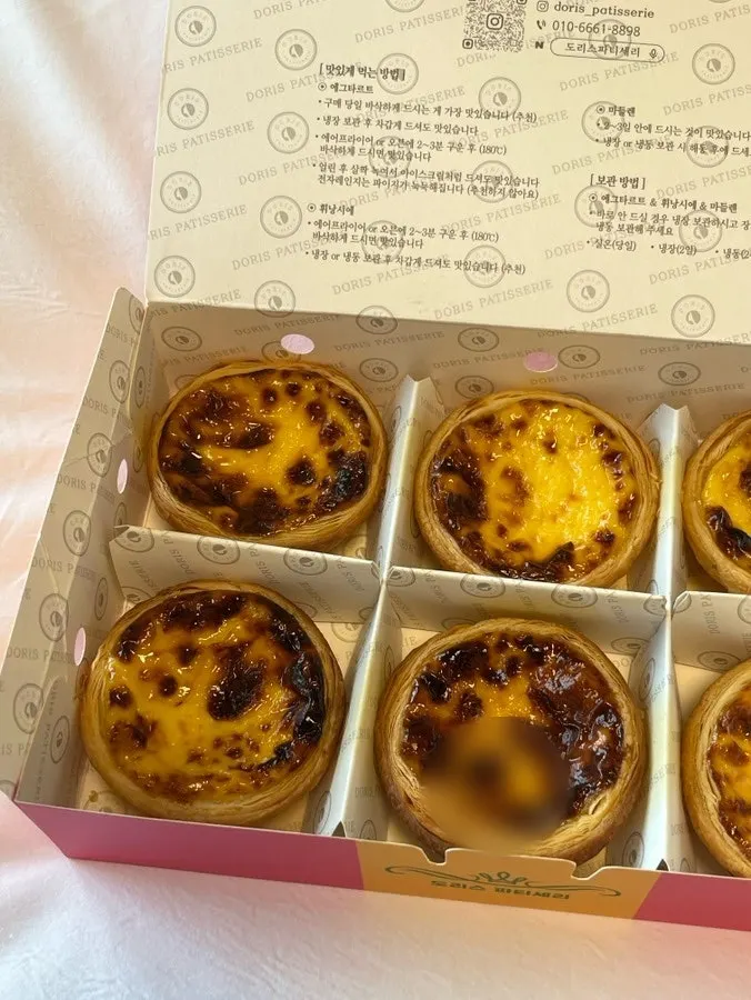 An egg tart held in hand