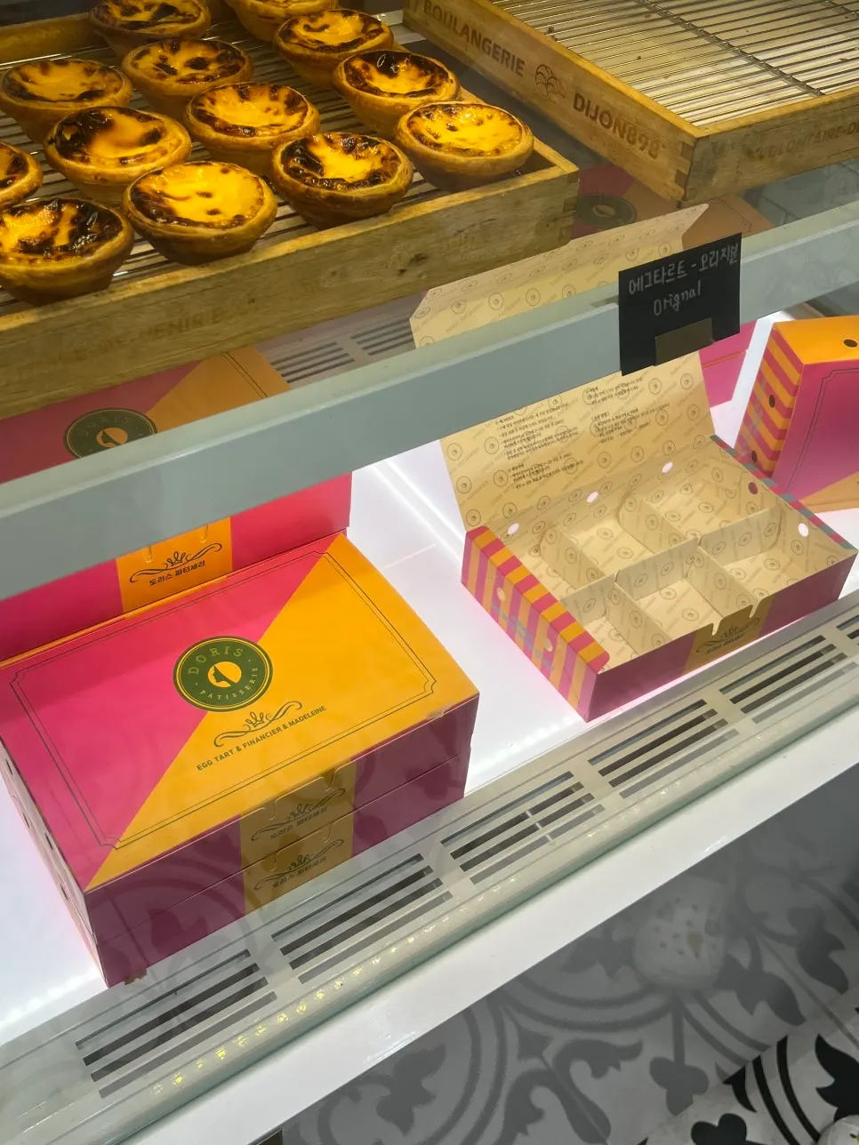 Store display case with egg tart flavor labels