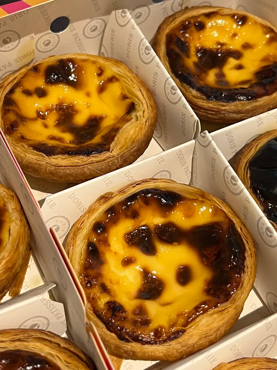 A row of egg tarts inside the box