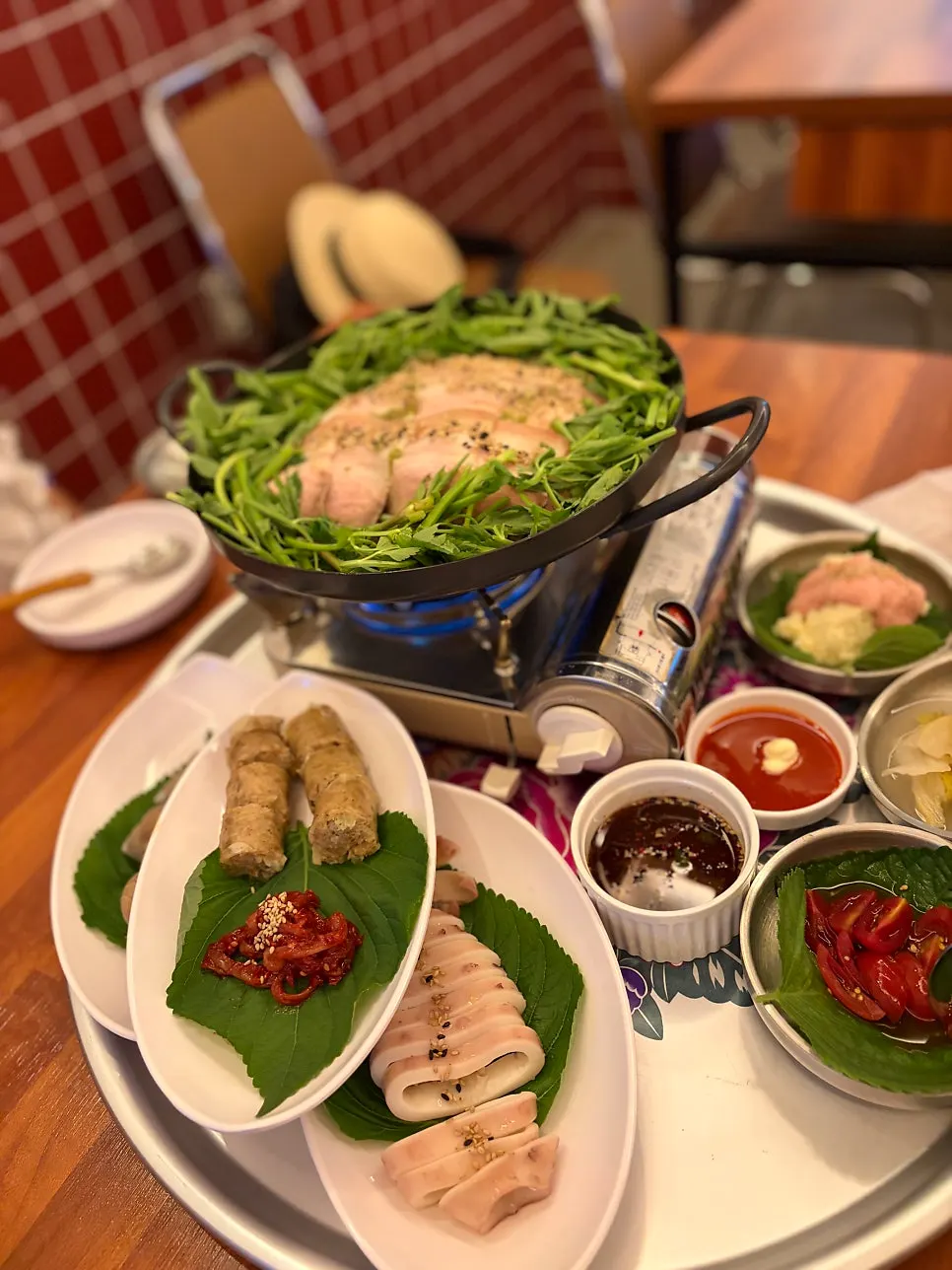 A full spread of warm boiled pork and seafood