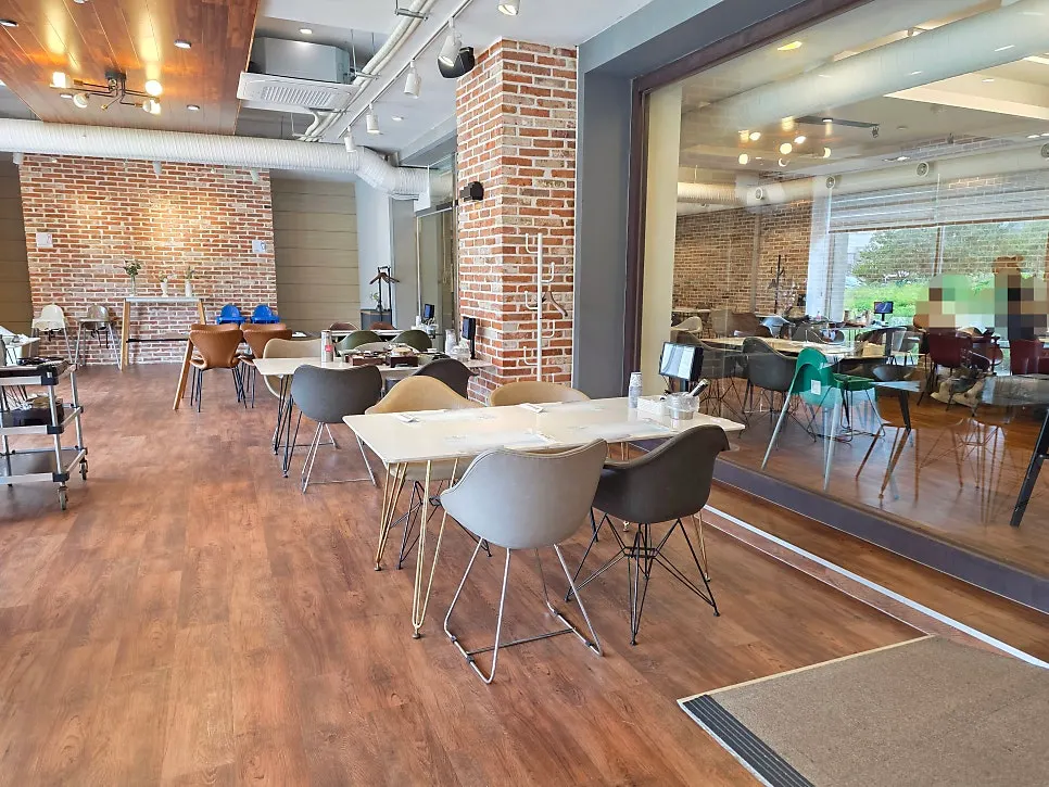 First seating area with floor-to-ceiling windows