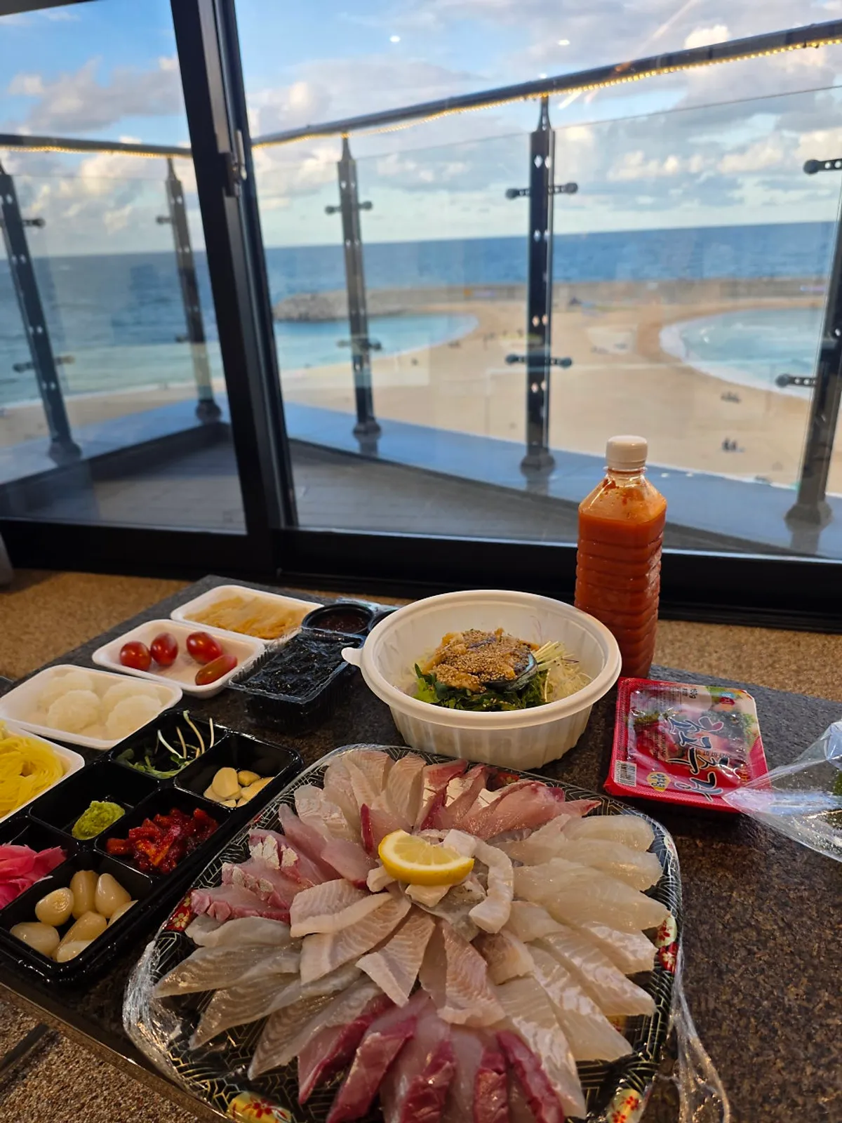 A sashimi spread with seaweed, lettuce wraps, and sushi rice