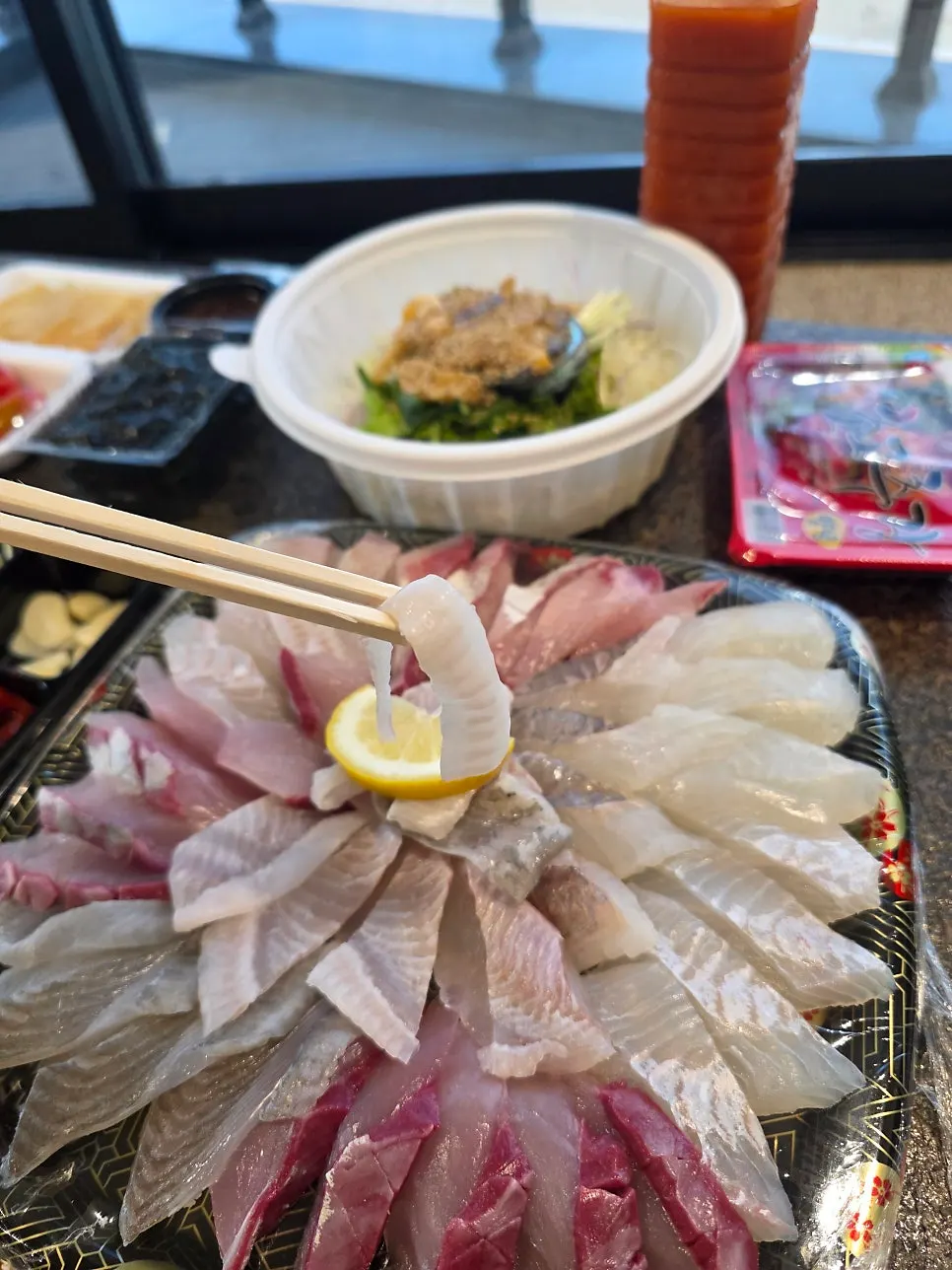 Fully unpacked small mixed sashimi platter spread
