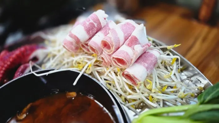 Beef being cooked in the shabu shabu broth