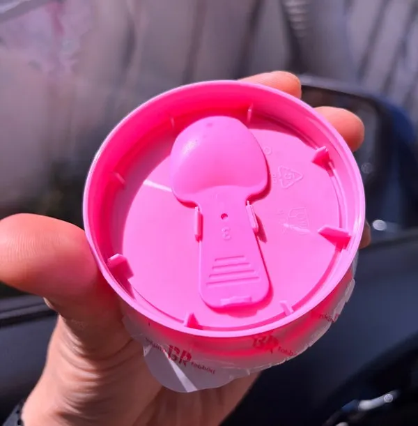 The cup ice cream lid with a built-in spoon