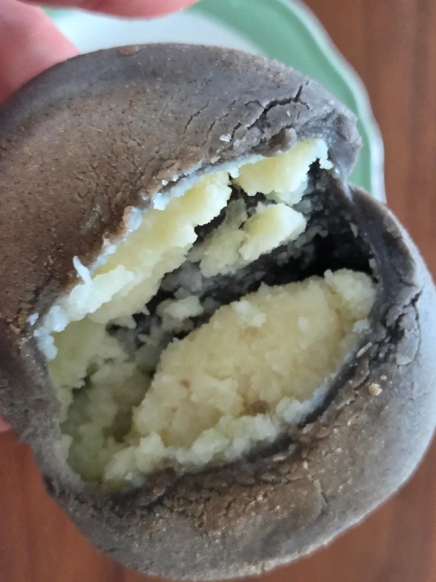 Potato bread cut in half showing cream cheese and potato filling
