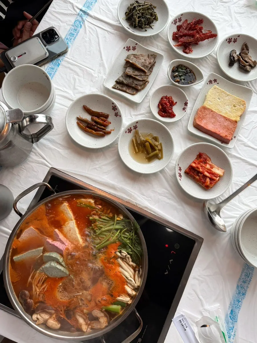 Tricolor sundubu stew with seafood, mushrooms, and minari