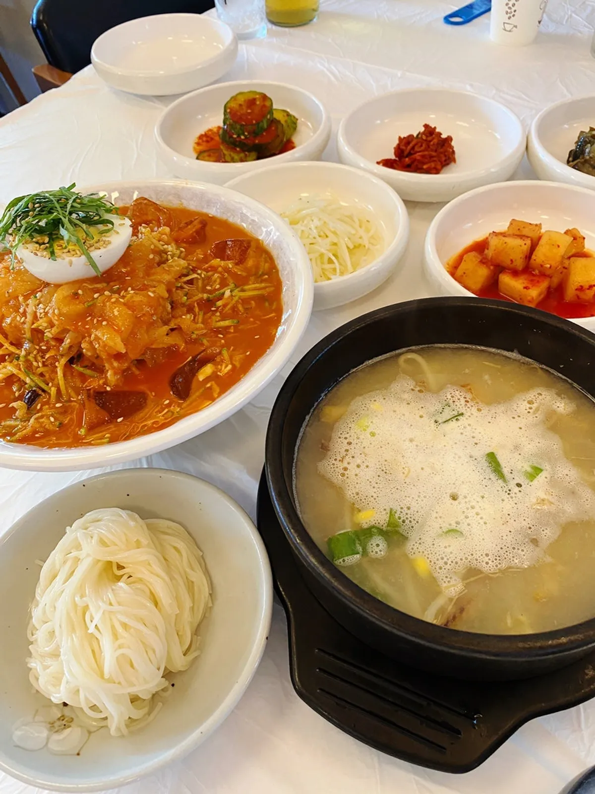 Banchan spread including diced radish kimchi and stir-fried potato