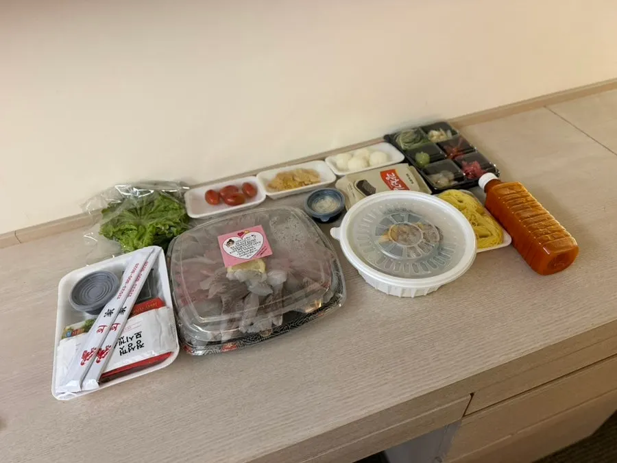 Hotel table spread with somyeon noodles and side dishes laid out