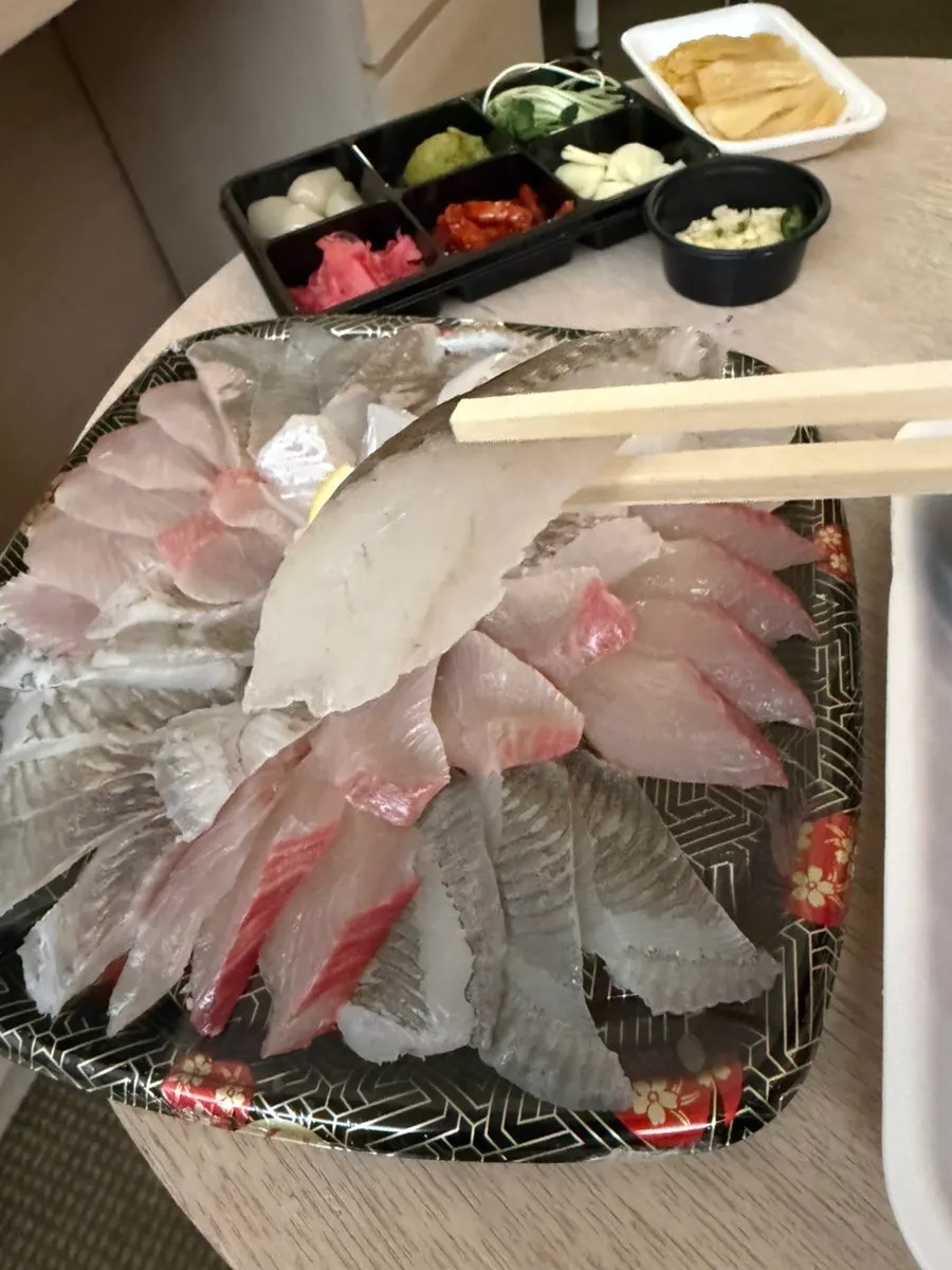 A plate of thick mixed sashimi with several kinds of fish
