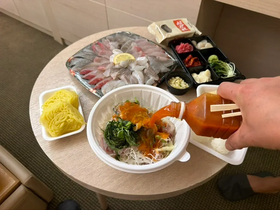 Takeout container of mulhoe with abalone and vegetables