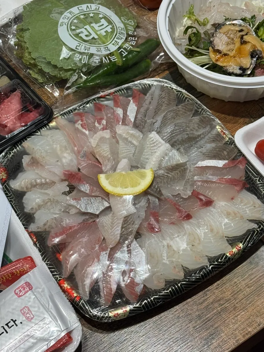 Takeout side dishes including ssamjang, minced garlic, and mukeunji