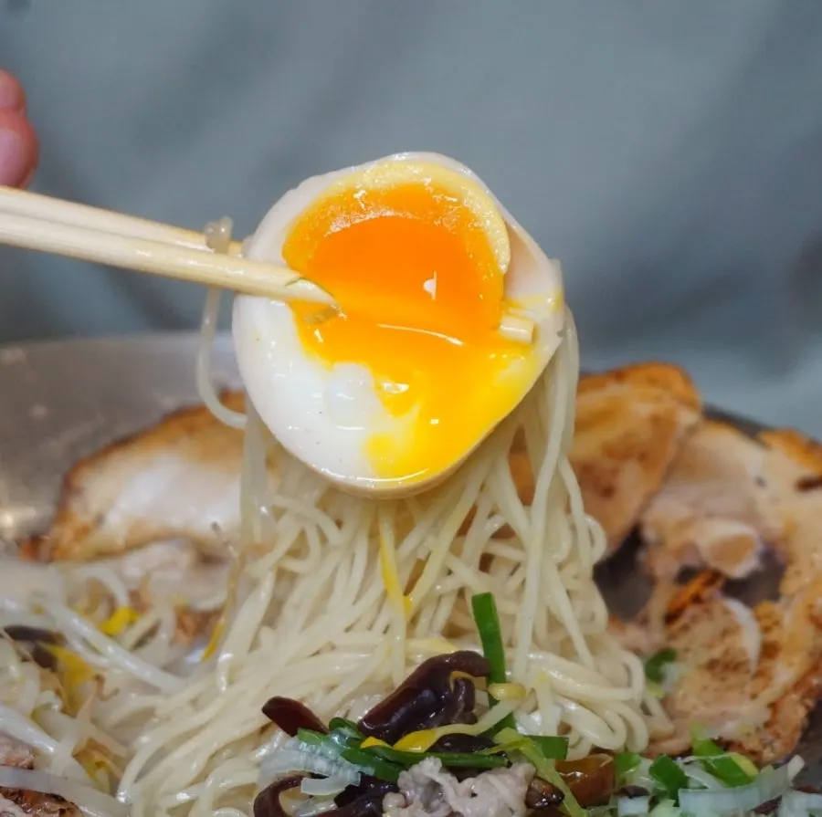 Char siu from the Special Tonkotsu Ramen lifted with chopsticks
