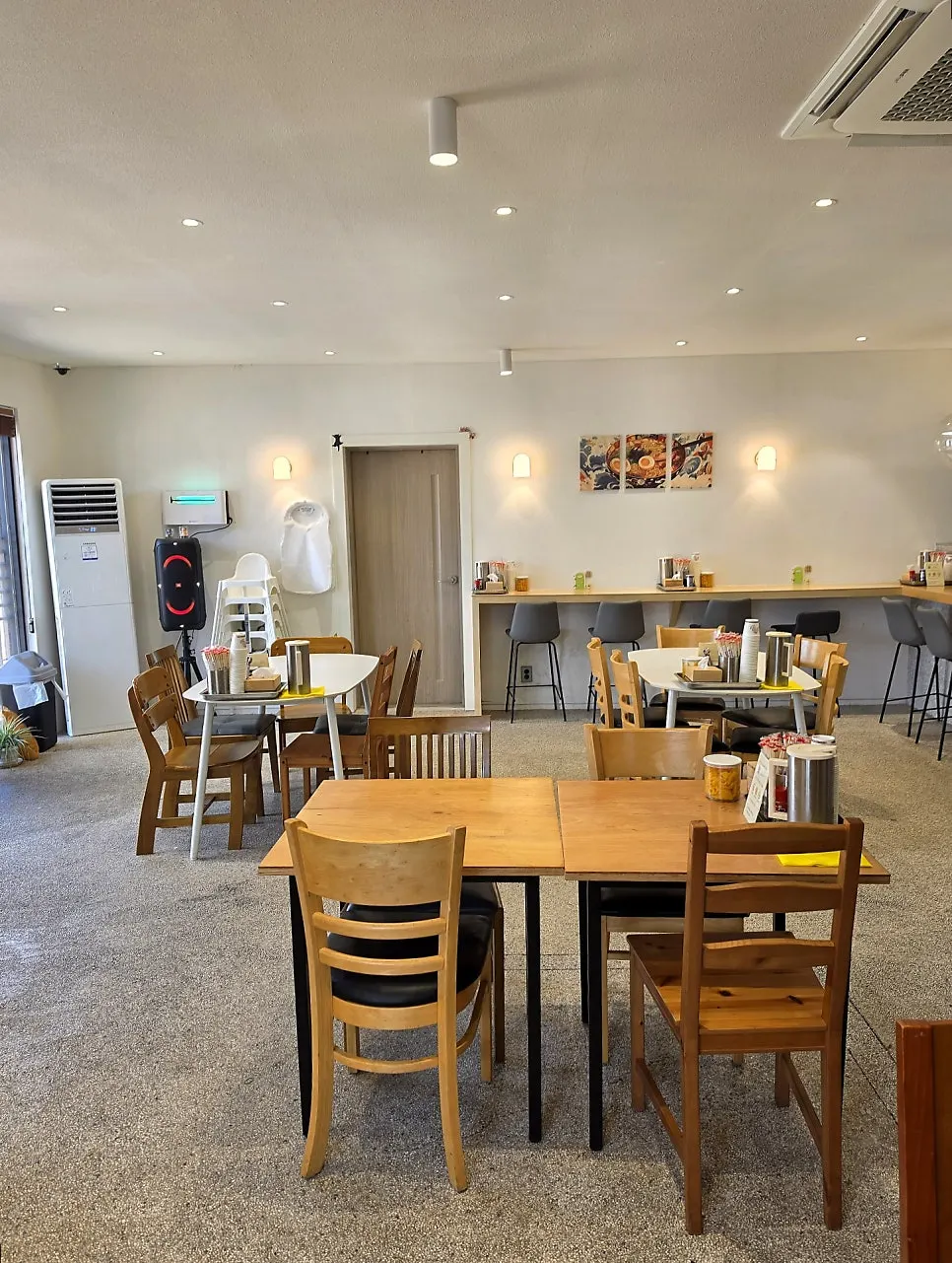 Dining area with bar-style seating in front of the kitchen at Ichiba Ramen