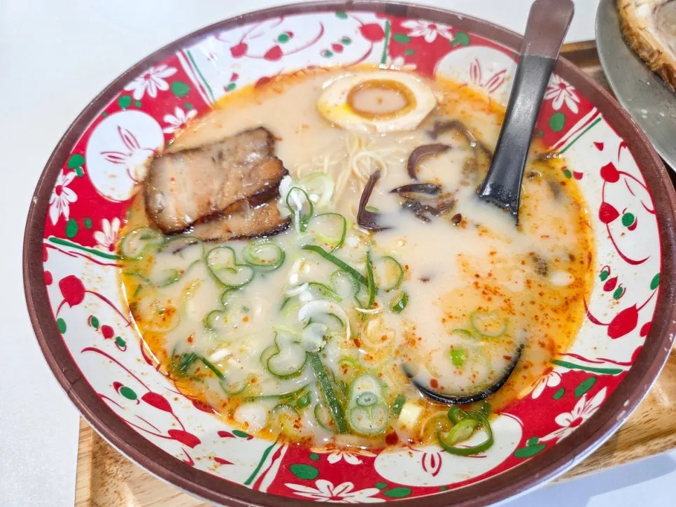 Noodles of the Karai Ramen lifted up with chopsticks