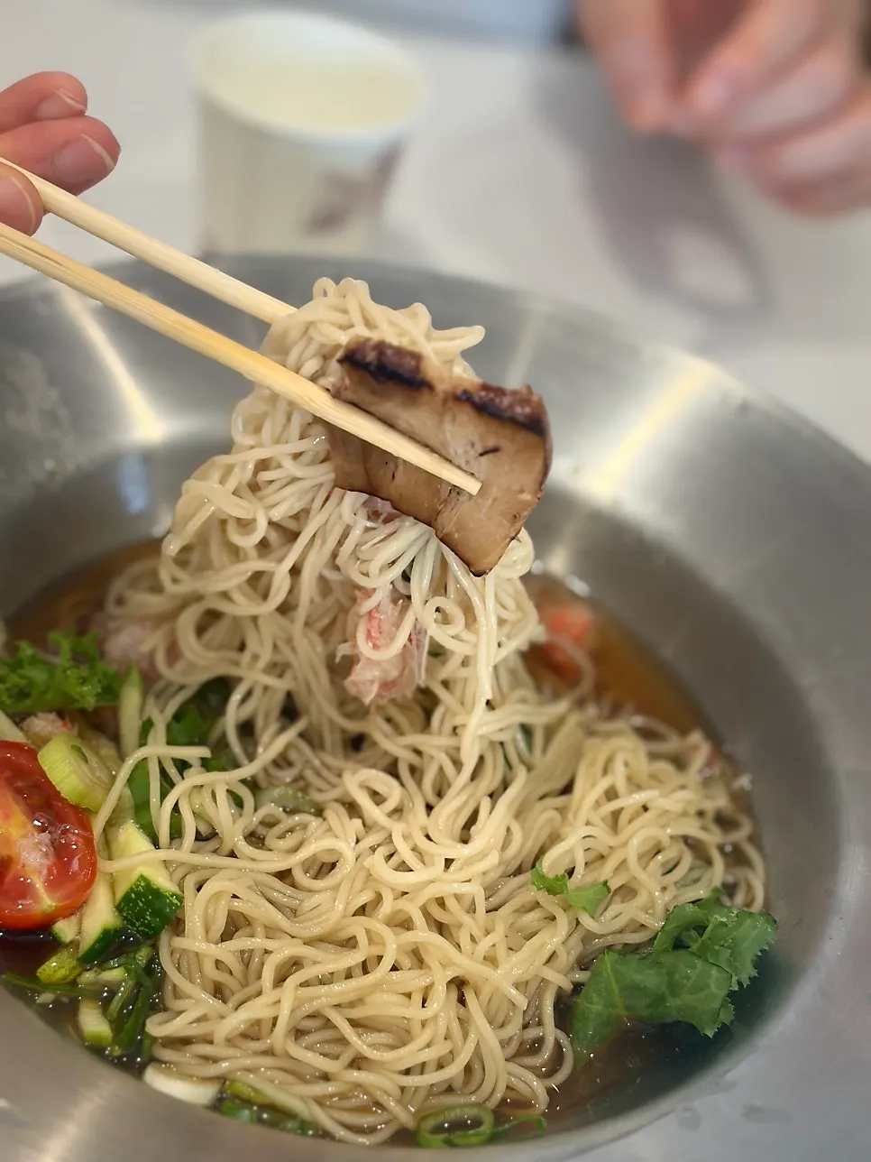 Noodles lifted up from tonkotsu ramen
