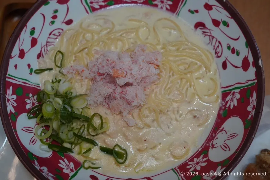 Scooping up tonkotsu ramen broth
