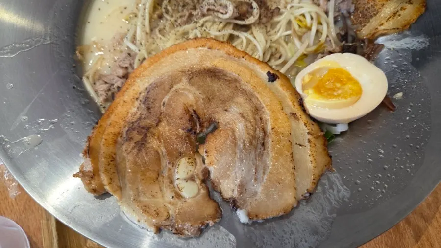 Noodles lifted up from the tonkotsu ramen