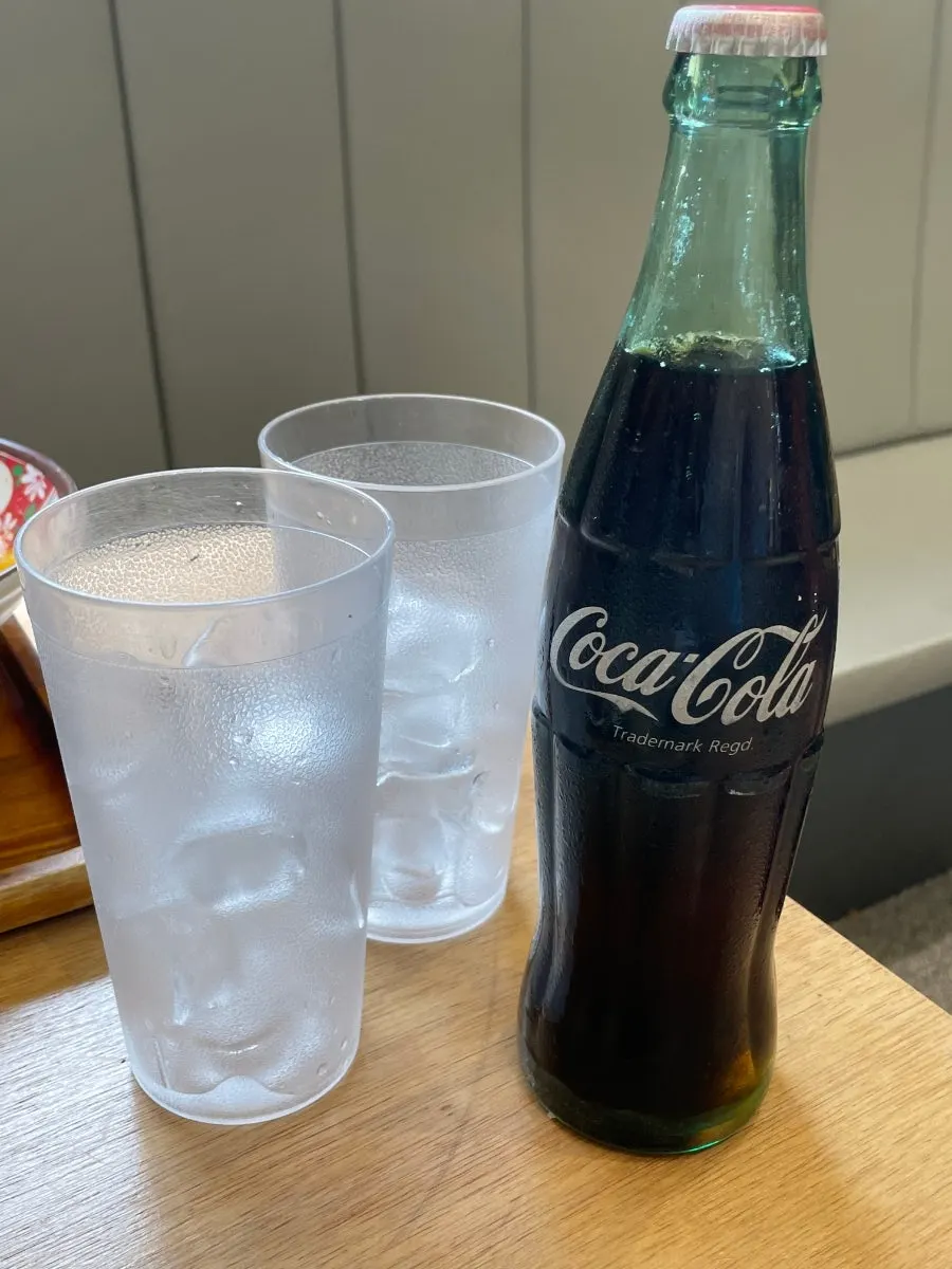 Nostalgic bottle cola served with a glass of ice