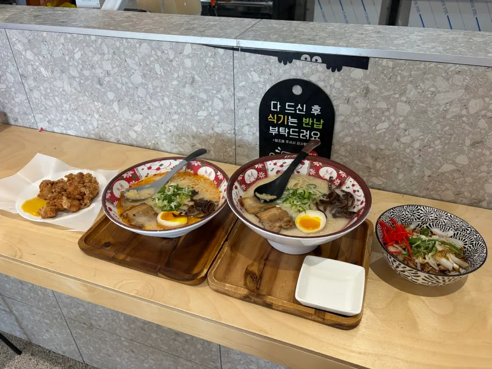 Table set with water, pickled radish, and chopsticks at Ichiba Ramen