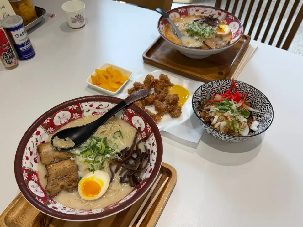 Tonkotsu ramen, karai ramen, butadon, and gara-age laid out on the table