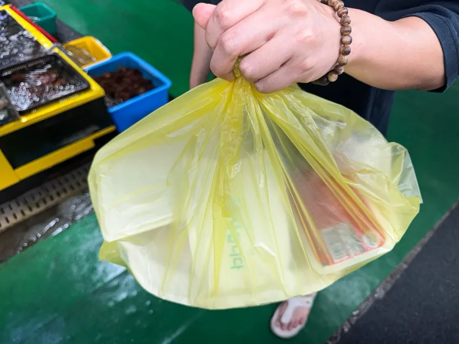 Packed bag of the farmed sashimi platter for two, ready for takeout