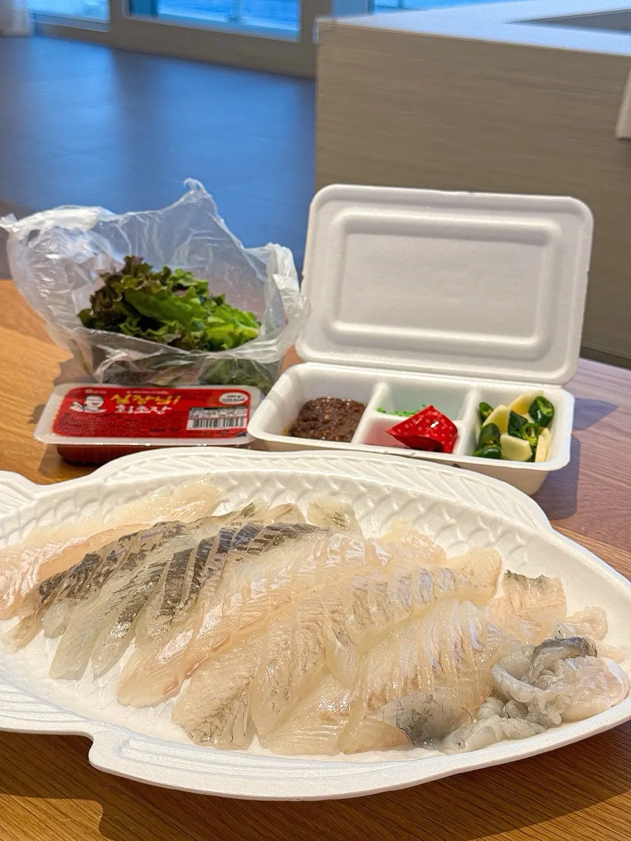 Opened container revealing the flounder and dab sashimi platter for two