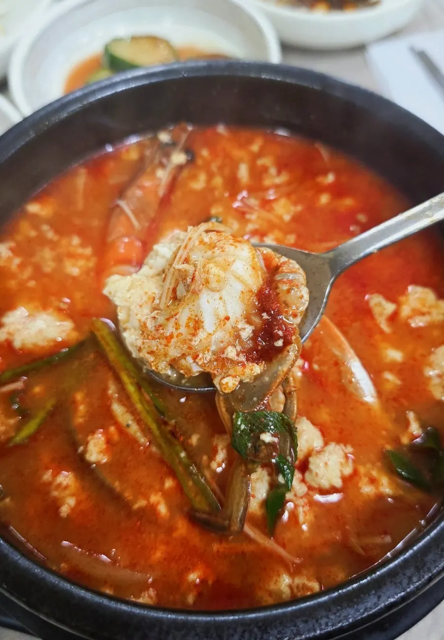 Close-up of jjamppong seafood sundubu bubbling in a stone pot