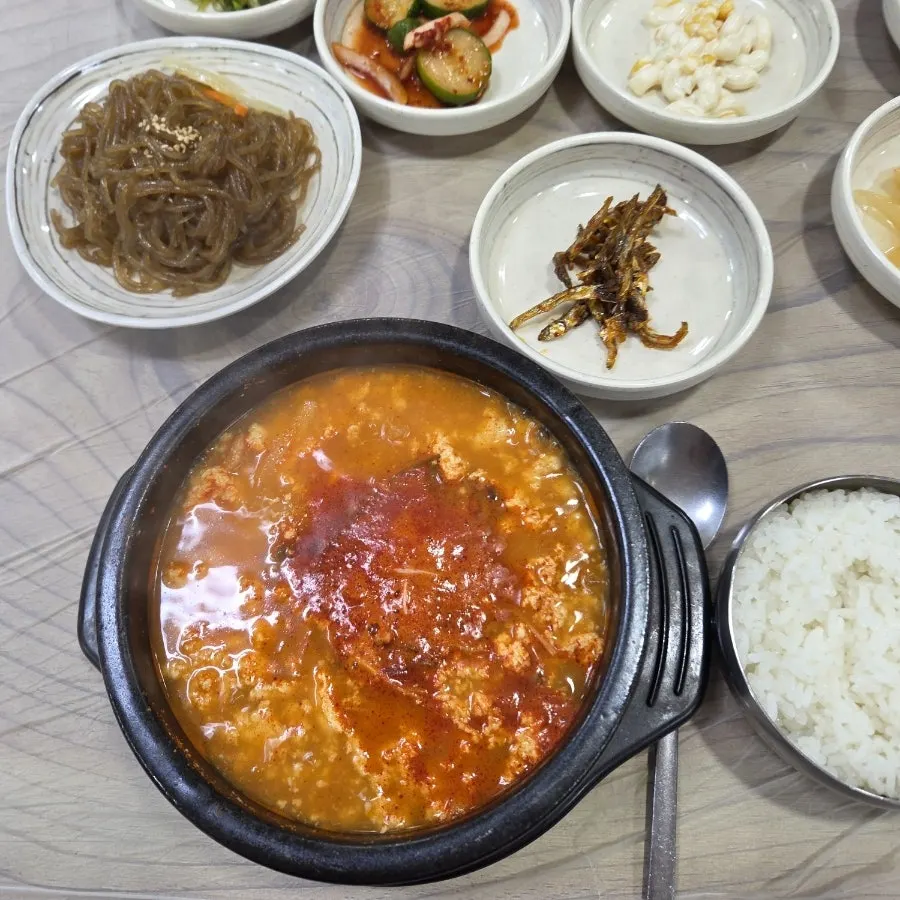 Spicy sundubu broth served with a bowl of rice