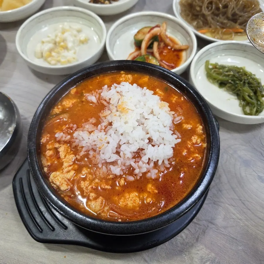 A meal of spicy sundubu eaten with rice