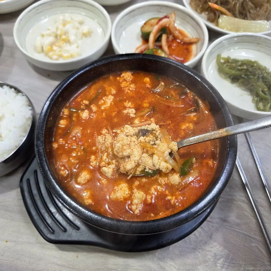 Table set with spicy sundubu and side dishes