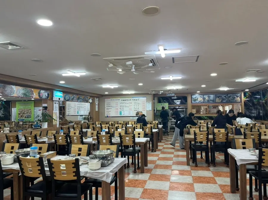 Large dining hall with seats already set for group guests