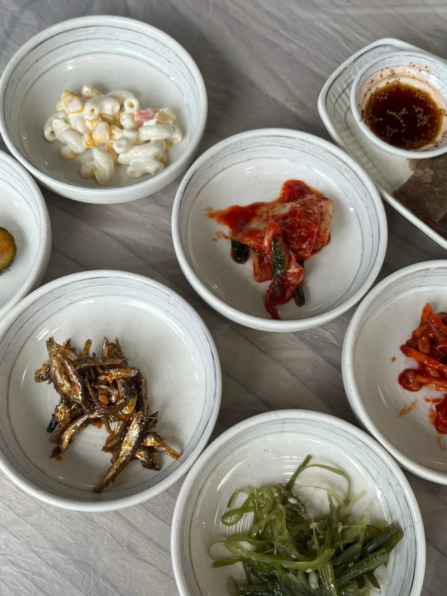 Bowl of Chodang sundubu served with the wild greens bibimbap