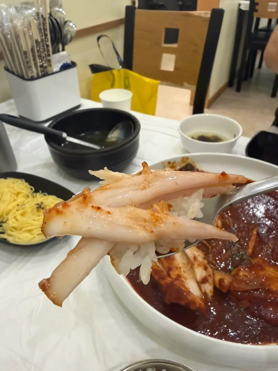 Chopsticks picking up a generous piece of skate meat