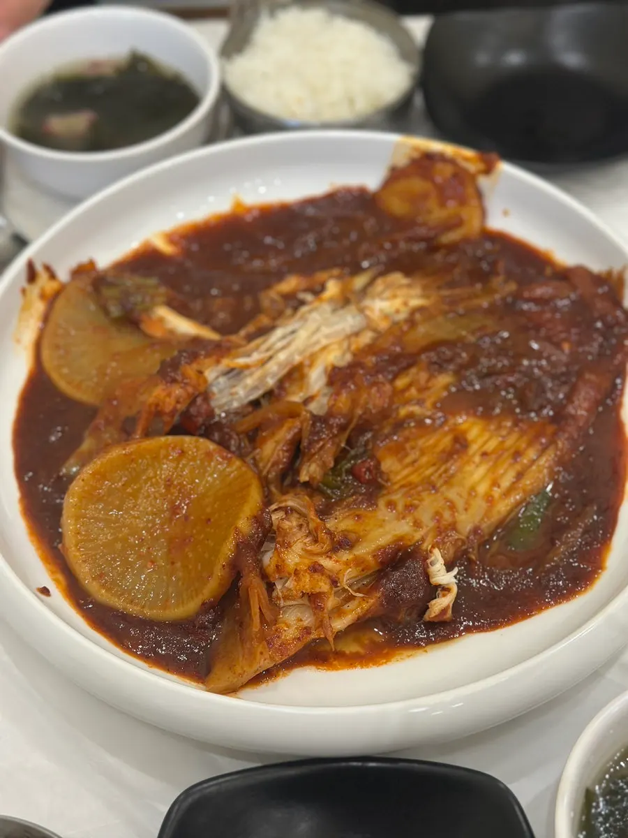 A piece of skate coated in spicy sauce
