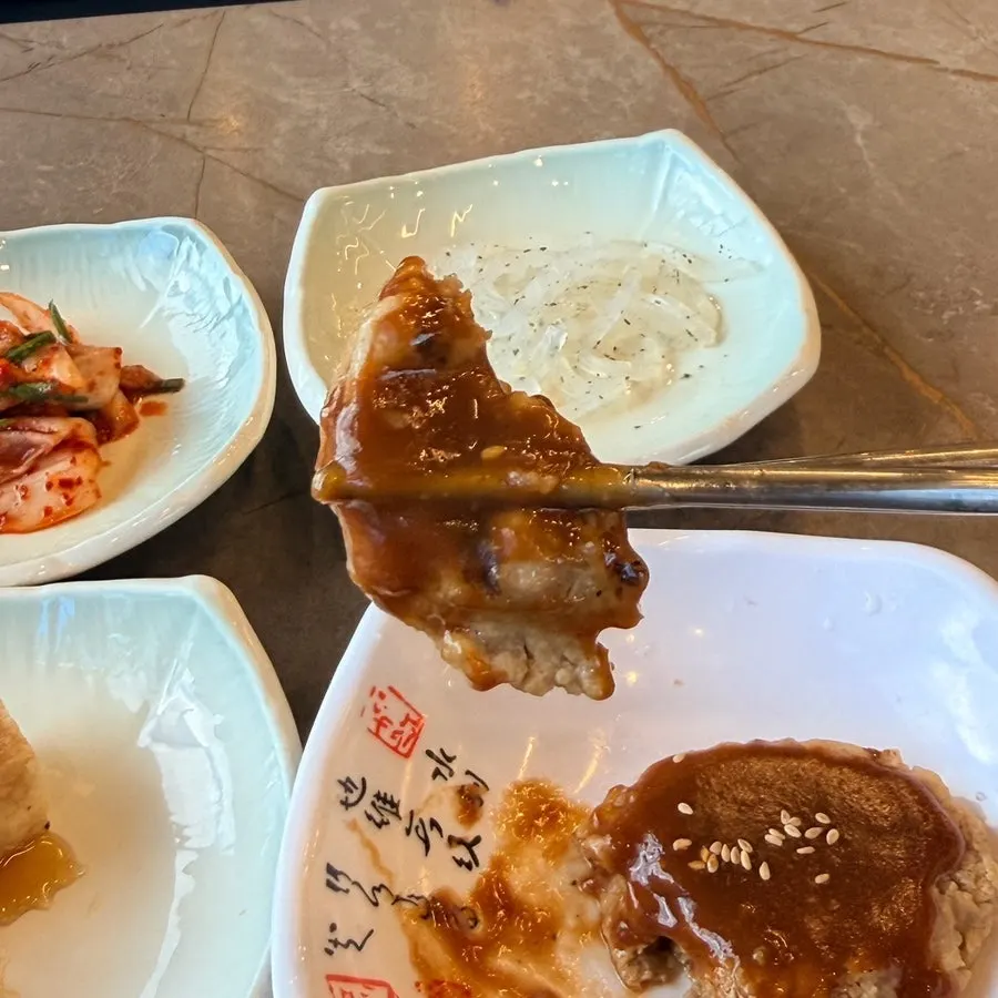 반찬을 한 점 집어 든 모습