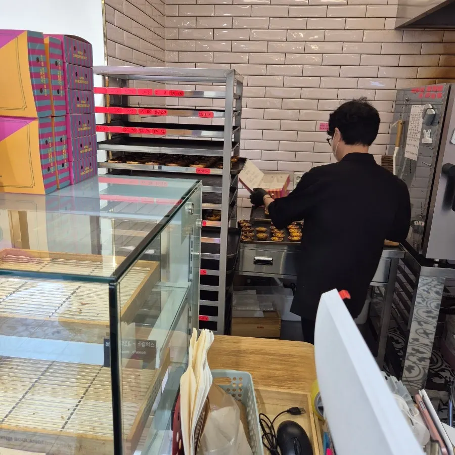 Egg tarts being packed into a signature box