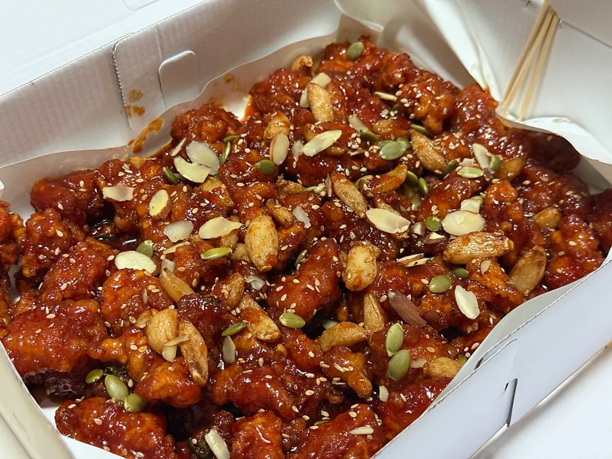 Takeout box of garlic dakgangjeong from Seomin Gapbu Sijang Dakjip