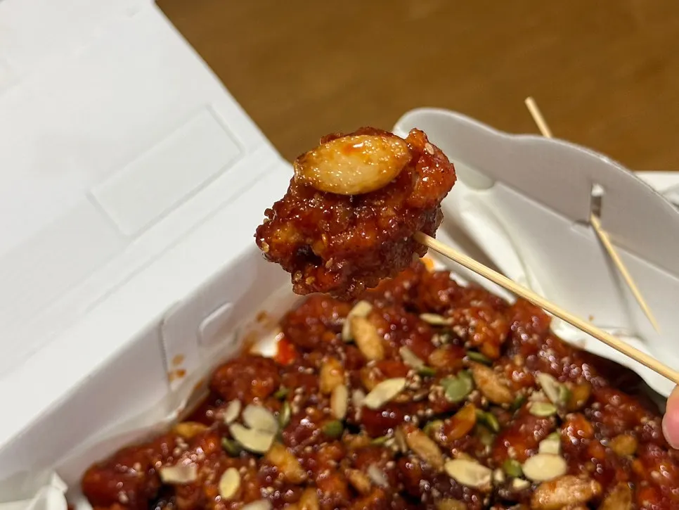 Close-up of garlic dakgangjeong tossed with fried garlic
