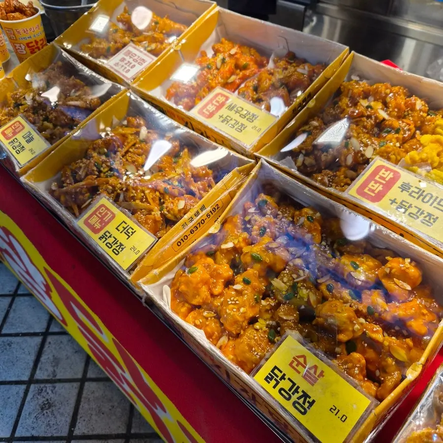 Boneless dakgangjeong piled up in the display case at Seomin Gapbu Sijang Dakjip